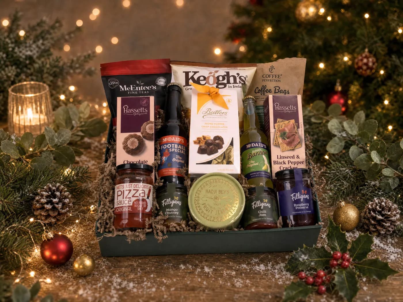 The All Ireland Food Hamper dressed for Christmas, holding McEntee’s tea, Keogh’s crisps, coffee bags, Butlers chocolates, McDaid’s minerals and Filligan’s preserves