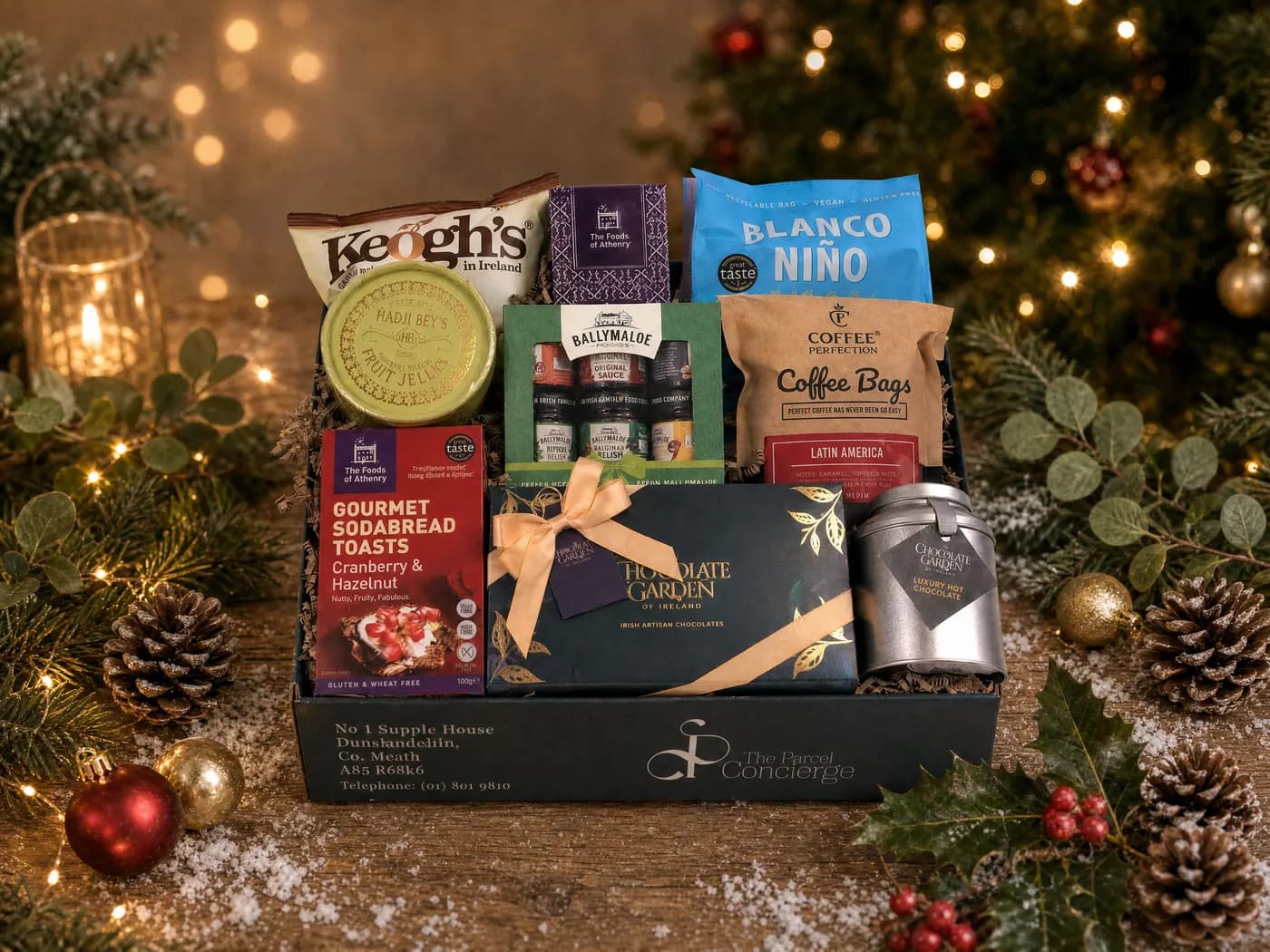 The Taste of Ireland Gluten Free Hamper dressed for Christmas, holding Keogh’s crisps, Blanco Niño tortilla chips, sodabread toasts, Hadji Bey jellies, a Ballymaloe relish set and Chocolate Garden chocolates